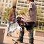 This boy is riding his skateboard on a sidewalk..jpg